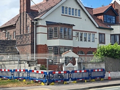 The damaged wall and gate at Redcroft, former home of Edgar Wood