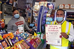 Councillor Shakil Ahmed (right) distributing information about the local guidelines