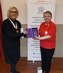 Maggie Mather (right) receiving the certificate and crystal from Vivien Carter MBE JP DL BEd