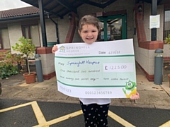 Lottie Harnett with the cheque for Springhill Hospice