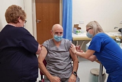 Dr Chris Duffy, CCG Chair and local GP, receiving his flu vaccination and Covid-19 booster