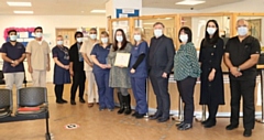 Jenna Johnstone (centre in the grey dress) with the Peterloo team