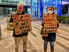 Reverend Mark Coleman and Jane Touil, Extinction Rebellion Rochdale, outside Number One Riverside with their placards