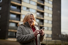 One of the beneficiaries, receiving her device with one year of minutes and data