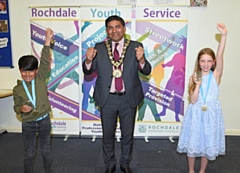 Children’s champion Grace (right) and deputy children’s champion Hashim (left) celebrating with the Mayor of Rochdale