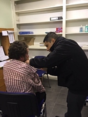 Dr Venk Mallya delivering flu vaccination at a local soup kitchen