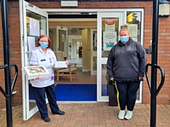 Ashleigh Bowles (right) presented Tudor Court with cakes and the £300 cash raised from her Captain Tom 100 challenge