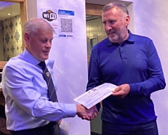 L-R: 71-year-old Bob Norbury presenting a £550 cheque to Shaun Gartland of SG6