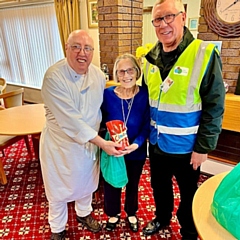 Chef Ken and Volunteer Driver Allan presented June with a box of Celebrations as a prize