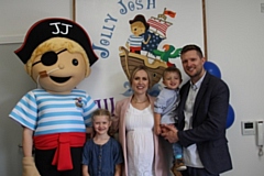 Jolly Josh opening - Carole and James Kelly with their children Oliver and Sophie, and the Jolly Josh mascot