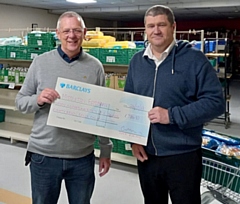 Chris Furlong gives a cheque to Carl Roach, of Middleton Foodbank in the Lighthouse Project