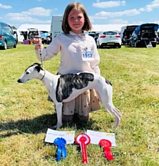 Darcie and Domino with their certificates and rosettes from the show