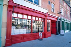 The Post Office in its signature red on South Parade 