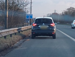 The black Renault was stopped as the driver was putting on make-up