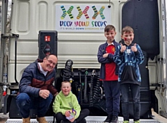 Brandon with his brothers Bradley and Jaxxon and grandad Steven on the back of the cab