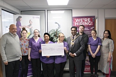 Members of the Community Careline Services presented Mayor Ali Ahmed with cheque for £1,000