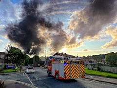 The fire involves a number of cars and a brick storage unit in a scrapyard