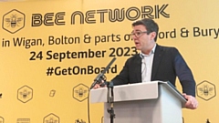 Greater Manchester mayor Andy Burnham with Bee Network branding