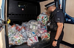 Officers with the confiscated items 