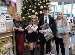 Helen Walton from the Rochdale Giving Back Christmas Toy Appeal with Cardinal Langley School pupils Oliver and Lucy