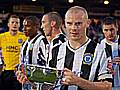 Gary Jones lifts the Rose Bowl after Rochdale's win