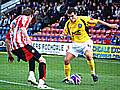 Adam Rundle, the man who assisted Rochdale's goal, takes on his Ben Starosta