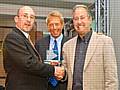 David Howles (right) receiving his award with TV presenter William Woollard (centre) looking on