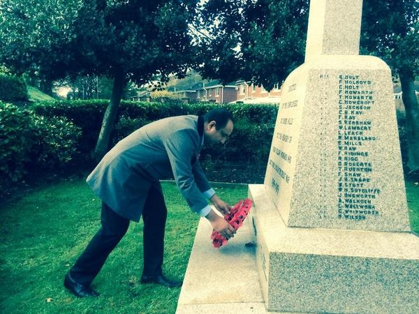 Cllr Aftab Hussain lays a poppy wreath at Shore Mill Memorial