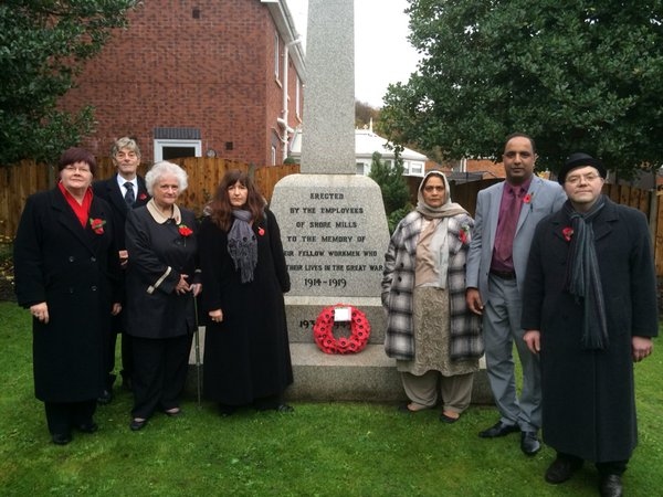 Pennine Councillors Janet Emsley, Robert Clegg, Ann Stott, Rina Paolucci, Amna Mir, Aftab Hussain and John Hartley laying a poppy wreath at the Shore Mills Memorial.