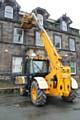 Stewart Greenwood clearing out the gutters of Hare Hill House